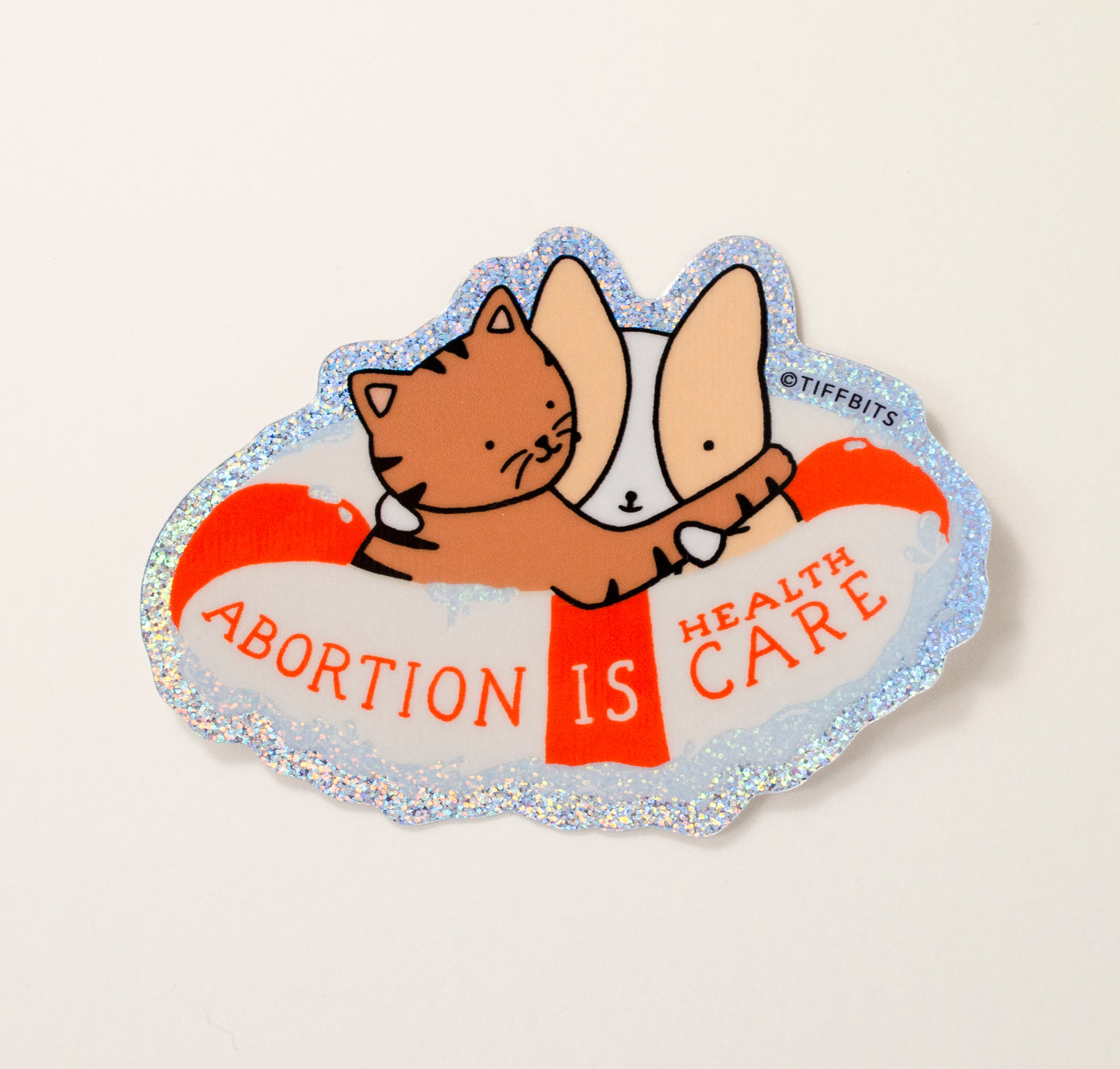A drawing of a brown tabby cat hugging a corgi inside a life saver ring and surrounded by water that is glittery blue