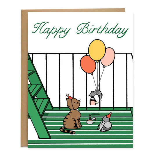 Card of a birthday party set on a green fire escape in NYC for a brown tabby cat wearing a birthday hat sitting with a pigeon wearing a birthday hat too and a rat floating down attached to three balloons holding a gift bag