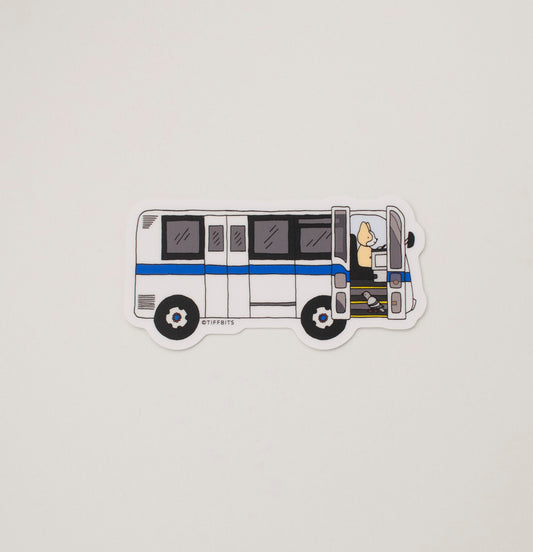 A drawing of an older NYC bus vehicle being driven by a cute dog and a pigeon passenger is boarding going up the stairs