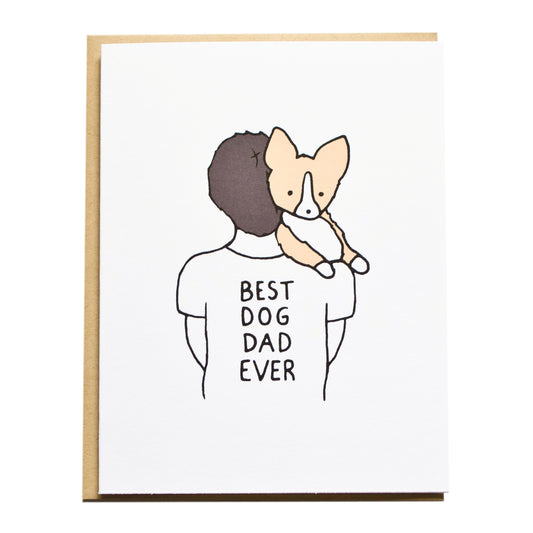 dad with brunette short hair carrying a corgi wearing a tshirt that reads best dog dad ever