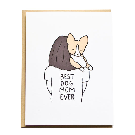 a mom with brunette hair carrying a corgi wearing a tshirt that reads best dog mom ever