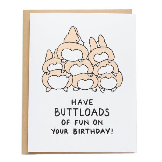 a pile of corgi butts. card reads: have buttloads of fun on your birthday!