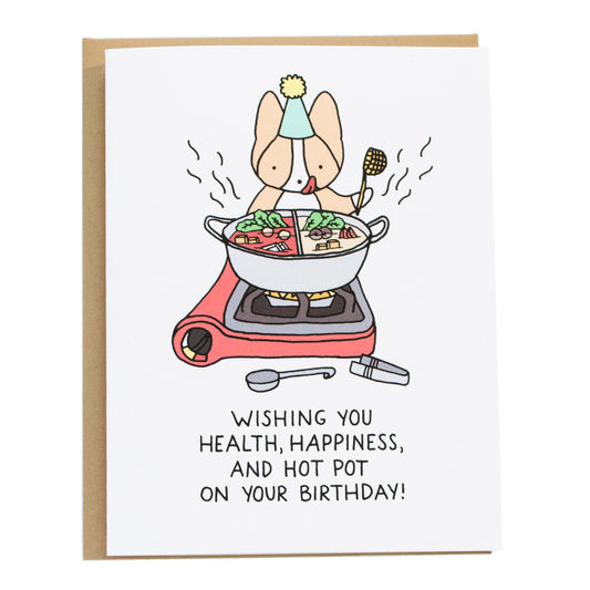 a corgi with a birthday hat on in front of a gas stove with a hot pot pan with a spicy and non spicy soup base with food inside, the card reads, wishing you health, happiness, and hot pot on your birthday!