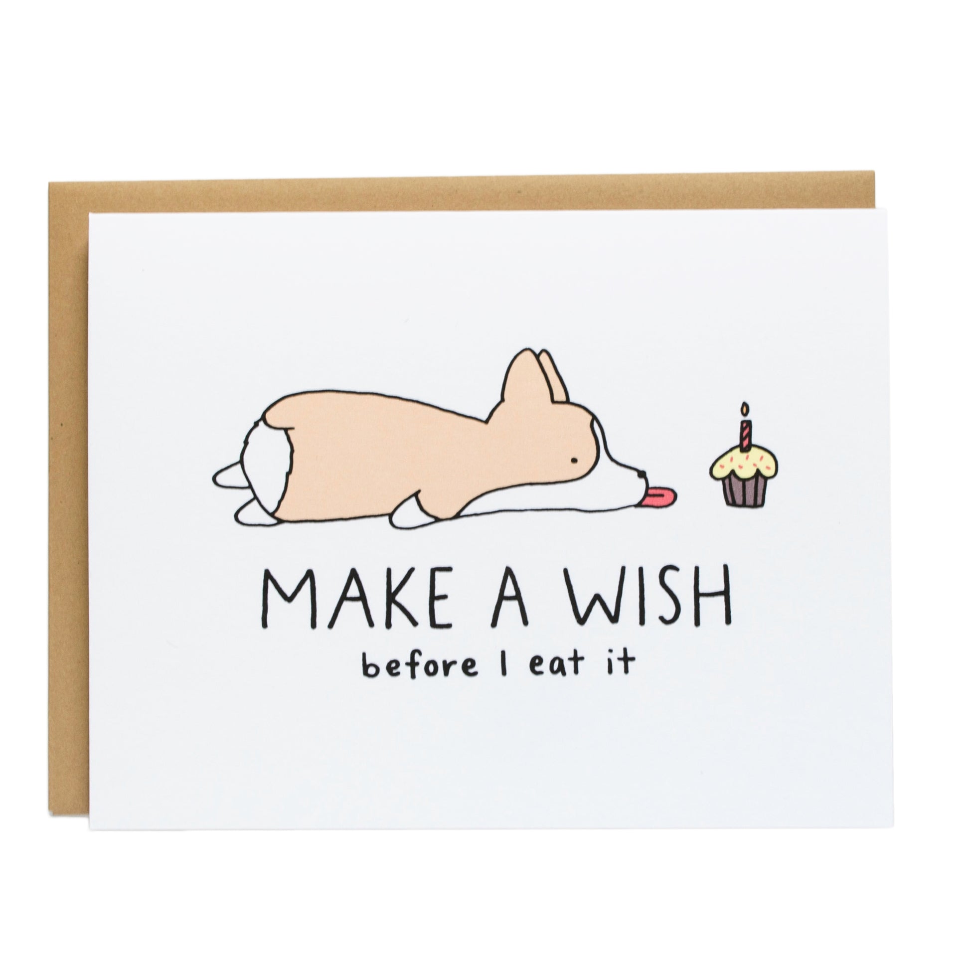 a corgi laying on its stomach with its tongue out next to a cupcake, the card reads, make a wish before i eat it