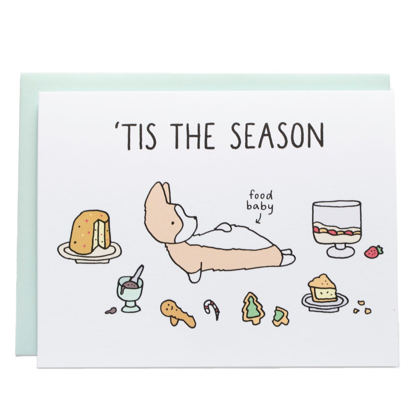 a corgi laying on its back holding its stomach with holiday desserts surrounding it (panettone, cookies, a trifle, pie, and ice cream). the card reads, tis the season and in smaller text, food baby, pointing at the corgi's stomach