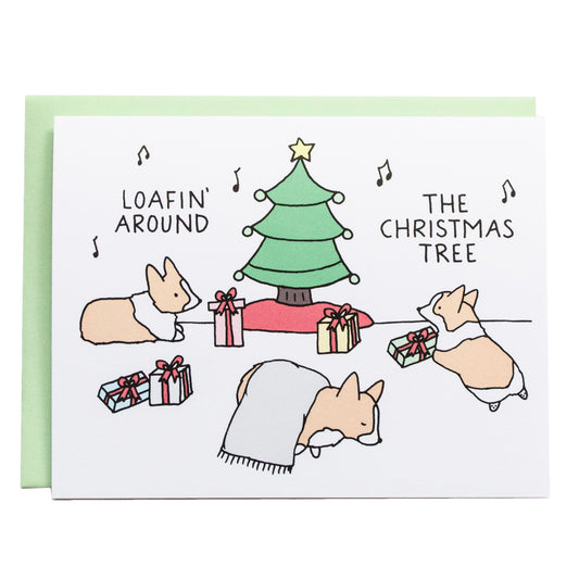 corgis laying or loafing around a christmas tree and music notes surround them. card reads, loafin around the christmas tree