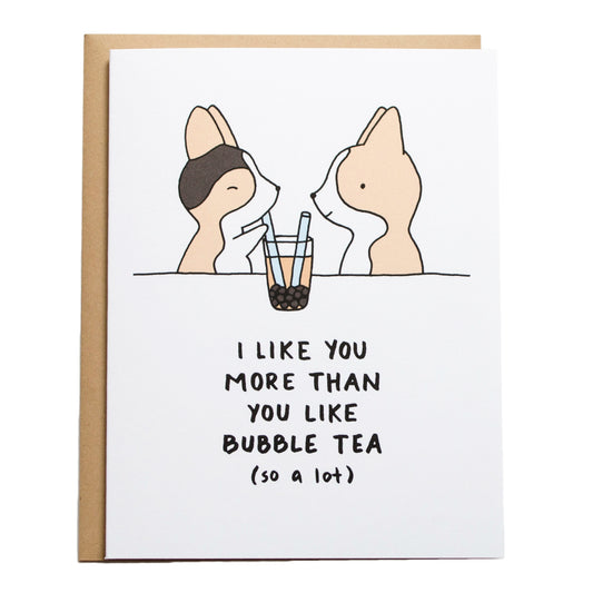 a tricolor corgi drinking a cup of bubble tea with two blue straws and another corgi is next to them looking, the card reads, i like you more than you like bubble tea (so a lot)