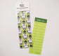 A green bookmark with a pattern design of a pigeon wearing a I Heart NY shirt and on the back is a book log design