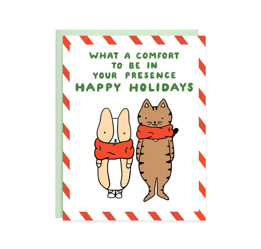 A card with a striped red and white border, in the middle is a drawing of a corgi and a brown cat wearing red snoods and text reads, what a comfort to be in your presence, happy holidays.