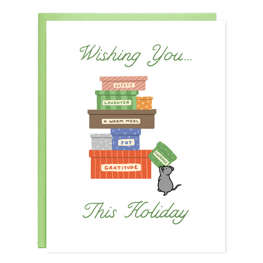 Greeting card with text on top that reads, 'Wishing you...' and in the middle an illustration of a pile of colorfully wrapped boxes that each reads, 'safety, laughter, a warm meal, joy, gratitude' with a rat running up to add another box that reads, 'courage.' On bottom the text reads, 'This Holiday'