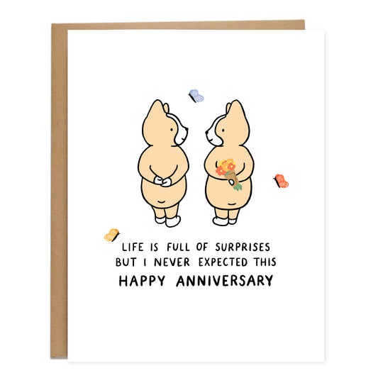 A drawing of two corgis standing with their hands behind their backs, and one corgi is holding a bouquet of flowers. Butterflies are around them and the text underneath reads, life is full of surprises but I never expected this, happy anniversary.