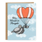 A card with a light blue background and clouds. In front is a heart shaped parachute with a rat holding hands with a pigeon, the card reads, Who Would've Thought in cursive lettering