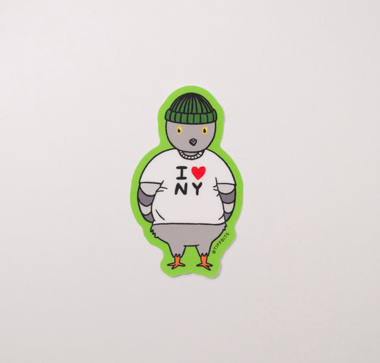 A sticker of a pigeon wearing a I Heart NY shirt and green beanie against a bright green background