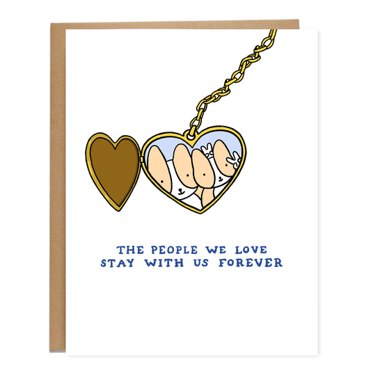 A drawing of a heart shaped, gold locket that's opened to a photo of a larger parent corgi holding up bunny ears behind a smaller corgi next to it holding up a peace sign. Text on the card reads, the people we love stay with us forever