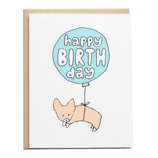 a corgi attached to a balloon floating and card reads happy birthday