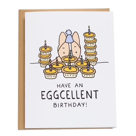 corgi peering over stacks of egg tarts and card reads have an eggcellent birthday