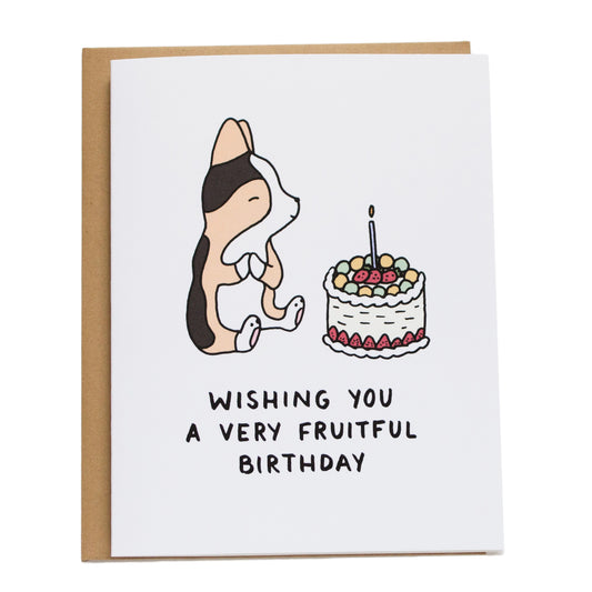 corgi making a wish with an asian fruit cake and card reads wishing you a very fruitful birthday