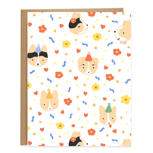 a colorful repeating pattern of corgis in birthday hats with red hearts, blue squiggles, flowers, and yellow and orange dots