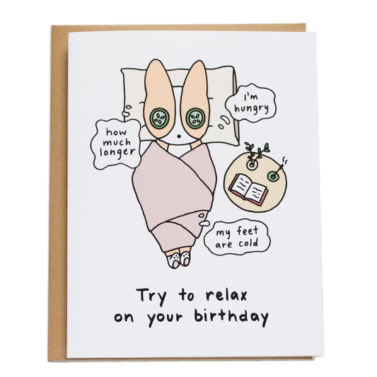 corgi with cucumber on its eyes wrapped in blanket thinking (how much longer, i'm hungry, my feet are cold) and card reads try to relax on your birthday