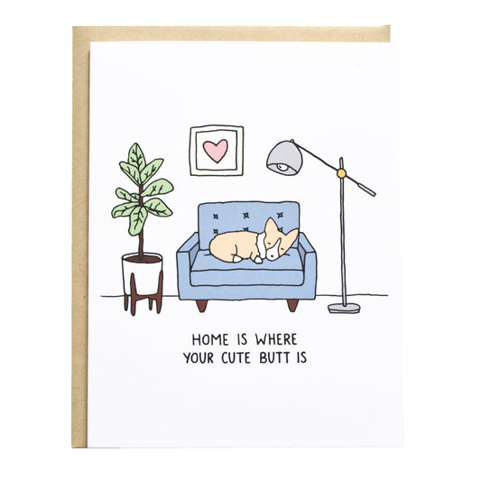 a corgi sleeping on a loveseat with a plant and lamp, card reads, home is where your cute butt is