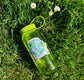 sticker on water bottle in the grass